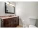 Powder room featuring a wood vanity with granite countertop, framed mirror and traditional fixtures at 1935 Northbrooke Ln, Dunwoody, GA 30338
