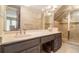 Spacious bathroom with a double sink vanity, tile backsplash, glass enclosed shower, and tile flooring at 1935 Northbrooke Ln, Dunwoody, GA 30338