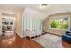 Bedroom featuring hardwood floors, a daybed, area rug, and a large window at 1935 Northbrooke Ln, Dunwoody, GA 30338