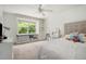 Bright bedroom with large window with built-in bench and shelving and neutral carpeting at 1935 Northbrooke Ln, Dunwoody, GA 30338