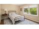 Bedroom featuring hardwood floors, a full-size bed, a window, and an area rug at 1935 Northbrooke Ln, Dunwoody, GA 30338