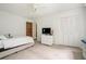 A bedroom with white trim, neutral carpet, and a large window at 1935 Northbrooke Ln, Dunwoody, GA 30338