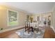 Bright dining room boasts hardwood floors and large windows overlooking the lush landscape at 1935 Northbrooke Ln, Dunwoody, GA 30338