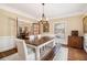 Dining room featuring a large wooden table with bench seating and a classic chandelier at 1935 Northbrooke Ln, Dunwoody, GA 30338