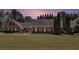 Charming brick home with a well-maintained lawn and mature trees under a colorful sky at 1935 Northbrooke Ln, Dunwoody, GA 30338