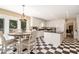 Bright eat-in kitchen with white cabinets, black countertops, checkerboard floors, and stainless steel appliances at 1935 Northbrooke Ln, Dunwoody, GA 30338