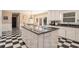 Bright eat-in kitchen with white cabinets, black countertops, checkerboard floors, and island at 1935 Northbrooke Ln, Dunwoody, GA 30338