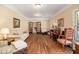 Formal living room boasts hardwood floors, a piano, and French doors to another room at 1935 Northbrooke Ln, Dunwoody, GA 30338
