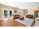 Spacious living room filled with natural light, gleaming hardwood floors, and neutral furniture at 1935 Northbrooke Ln, Dunwoody, GA 30338