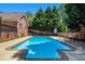 A refreshing in-ground pool, basketball hoop, and deck chairs make this backyard perfect at 1935 Northbrooke Ln, Dunwoody, GA 30338