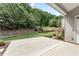 Patio overlooking a green backyard surrounded by mature trees and landscaping at 1955 Overlook Run Pl, Cumming, GA 30040