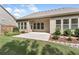 A covered patio extends to a concrete backyard with ample natural light and a well-maintained lawn at 1955 Overlook Run Pl, Cumming, GA 30040