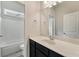 Beautiful bathroom showcasing a vanity with white countertop, dark cabinetry, and tub-shower combo at 1955 Overlook Run Pl, Cumming, GA 30040
