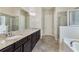 Elegant bathroom featuring double vanity, granite countertop, tile flooring, and separate shower and tub at 1955 Overlook Run Pl, Cumming, GA 30040