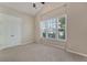 Bright bedroom with large windows, neutral walls, ceiling fan, and double door closet at 1955 Overlook Run Pl, Cumming, GA 30040