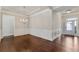 Elegant dining space with hardwood floors, crown molding, and chandelier at 1955 Overlook Run Pl, Cumming, GA 30040