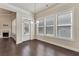 Bright dining room with three large windows, a glass door, and hardwood flooring at 1955 Overlook Run Pl, Cumming, GA 30040