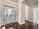 Warm foyer featuring hardwood floors, a storm door, and neutral wall colors at 1955 Overlook Run Pl, Cumming, GA 30040