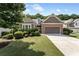 Charming home with a brick facade, manicured landscaping, and a two-car garage at 1955 Overlook Run Pl, Cumming, GA 30040