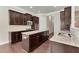 Modern kitchen with granite counters, dark wood cabinets, and stainless steel appliances at 1955 Overlook Run Pl, Cumming, GA 30040