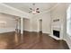 Bright living room with hardwood floors, fireplace, and large windows for natural light at 1955 Overlook Run Pl, Cumming, GA 30040