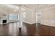 Open living room with hardwood floors, a fireplace, and large windows for natural light at 1955 Overlook Run Pl, Cumming, GA 30040