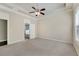 Generous main bedroom with tray ceiling, ceiling fan, and adjacent bath at 1955 Overlook Run Pl, Cumming, GA 30040
