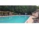 Community pool and lounge area with umbrellas and pergola for shade on sunny days at 1955 Overlook Run Pl, Cumming, GA 30040