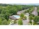 Aerial shot showcasing a community with mature trees, a pool, and townhomes at 2910 Cross Creek Dr, Cumming, GA 30040