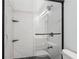 Modern bathroom featuring a tiled shower with black hardware and glass doors at 2910 Cross Creek Dr, Cumming, GA 30040