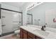 Modern bathroom with a sleek glass-enclosed shower, dark wood vanity, and quartz countertops at 2910 Cross Creek Dr, Cumming, GA 30040
