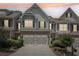 Charming townhome with a two-car garage, manicured landscaping, and a welcoming facade at 2910 Cross Creek Dr, Cumming, GA 30040