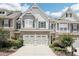 Charming townhome with a two-car garage, manicured landscaping, and a welcoming facade at 2910 Cross Creek Dr, Cumming, GA 30040