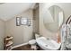 Small, convenient half bathroom with modern fixtures, a round mirror, and decor at 2910 Cross Creek Dr, Cumming, GA 30040