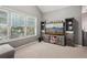 Bright living room showcasing a TV on rustic shelving with a window view at 2910 Cross Creek Dr, Cumming, GA 30040