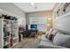 Inviting home office features a cozy sofa, functional desk, and bright window at 2910 Cross Creek Dr, Cumming, GA 30040
