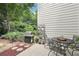 Outdoor patio with grill, table with seating, and landscaped yard at 2910 Cross Creek Dr, Cumming, GA 30040