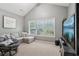 Cozy sitting area with window, comfortable gray sofa and Papasan chair at 2910 Cross Creek Dr, Cumming, GA 30040
