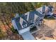 Stunning aerial view of a spacious home with a driveway and beautiful landscaping in a wooded neighborhood at 3448 Craggy Perch, Douglasville, GA 30135
