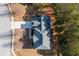 Aerial view of a house showcasing the roof, driveway, and surrounding trees at 3448 Craggy Perch, Douglasville, GA 30135