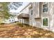 Backyard featuring a wooden deck above and ample green space surrounded by trees and houses nearby at 3448 Craggy Perch, Douglasville, GA 30135