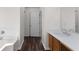 Well-lit bathroom featuring a tub, wood-look flooring, a modern vanity, and a clean design, perfect for everyday use at 3448 Craggy Perch, Douglasville, GA 30135