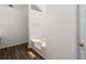 Clean bathroom showcasing a white tub, wood-look floors, and a minimalist design, perfect for relaxation at 3448 Craggy Perch, Douglasville, GA 30135