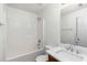 Bright bathroom features a shower-tub combo, modern fixtures, and a neutral color palette at 3448 Craggy Perch, Douglasville, GA 30135