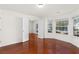 Comfortable living room with hardwood floors, three large windows and double doors at 3448 Craggy Perch, Douglasville, GA 30135