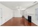 Sunlit living room with hardwood floors, staircase, fireplace, and neutral paint at 3448 Craggy Perch, Douglasville, GA 30135