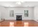 Open living room with hardwood floors, fireplace and bright, natural light from two windows at 3448 Craggy Perch, Douglasville, GA 30135