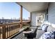 Relaxing covered back porch with a dark gray seating and tree-lined vista beyond at 4720 Montane St, Cumming, GA 30028