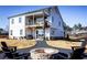 Expansive backyard features a covered porch, rear deck, and open-air dining area with fire pit at 4720 Montane St, Cumming, GA 30028