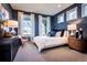 Bedroom with bright blue walls, a plush bed, and large windows with sheer white curtains at 4720 Montane St, Cumming, GA 30028